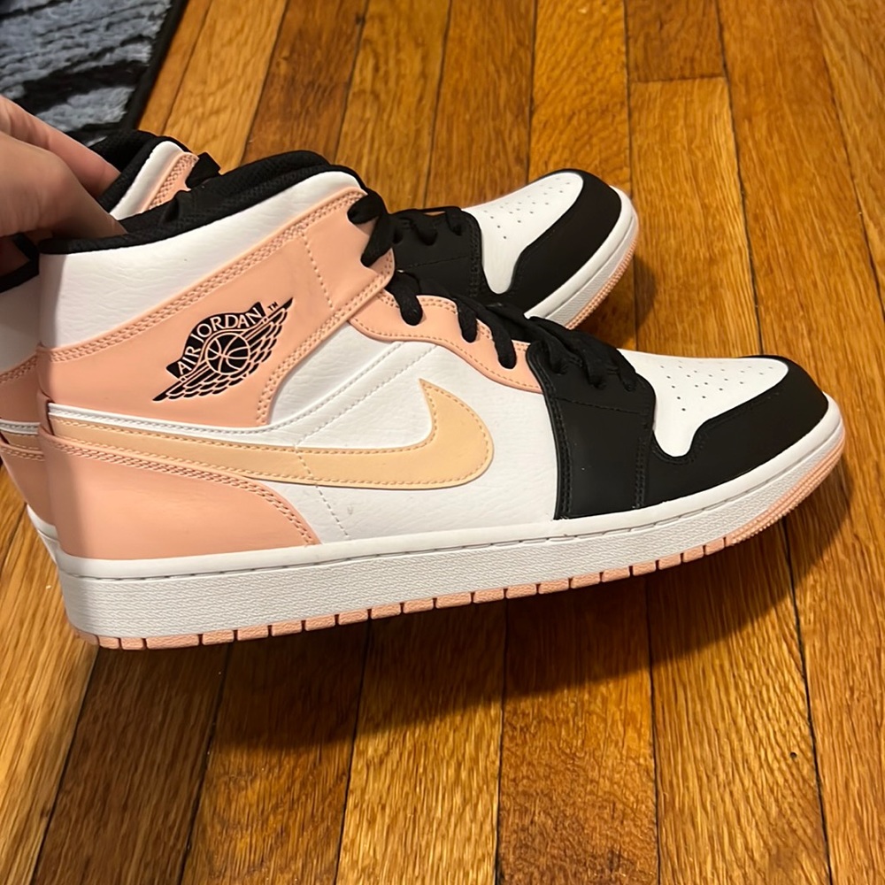 Black and light pink Jordan one mids